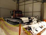 The snow groomer is taking a break