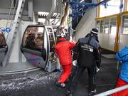 Friendly staff assist with boarding at the gondola lift