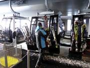 The staff assists with boarding the gondola lift.