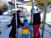 Small children are assisted during boarding