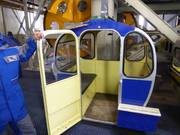 The friendly staff assists with boarding the gondola lift.