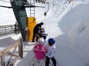 Small children are assisted at the platter lift