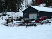 The snow groomers are waiting for their next assignment.