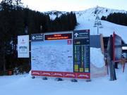 Detailed information board with slope map and operating status in the KitzSki ski area