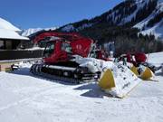 The snow groomers are waiting for their next assignment.