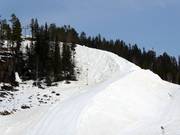 The snow is preserved under tarpaulins over the summer.