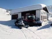 The snow groomer is taking a break