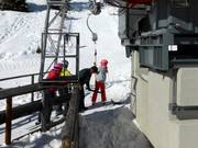 Staff hands you the T-bar at the drag lift