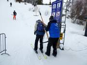 Poles are handed to skiers at the tow lift.
