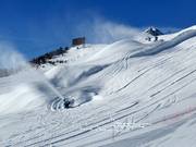 High-performance snow cannons cover the Corviglia Run with artificial snow.