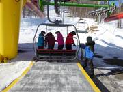Staff assist with boarding at the chairlifts
