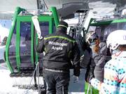 The staff assists with boarding the gondola lift.