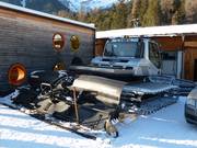 The snow groomer is taking a break