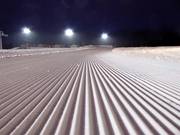 Freshly groomed slope for night skiing