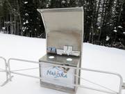 "Sniffle Station" at the entrance with waste bin