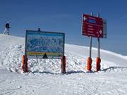 Slope signage with trail map in the ski resort