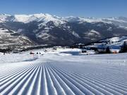 Perfectly groomed slope in the Obersaxen ski area