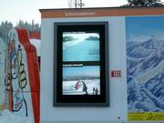 Information board at the central ticket desk with live footage from the web cams