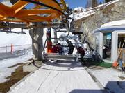 The friendly staff assists with boarding at the chairlift.