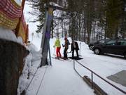 Poles are handed to skiers at most of the tow lifts