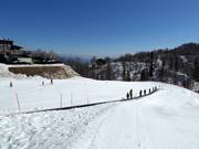 Practice slope with conveyor belt at the mountain station of the cable car