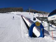 Tip for children  - Moving carpet in the Livigno ski resort.