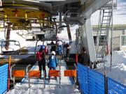 Children are assisted when boarding the chairlift.